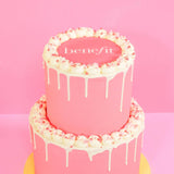 2 Tier Corporate Drip Cake with logo featuring pink Swiss Meringue icing and edible company logo plaque